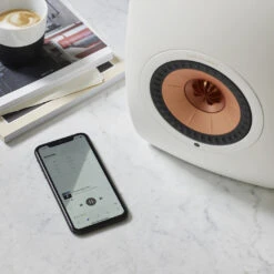 KEF LS50 Wireless II Powered Bookshelf Speaker System -Trendy Electronic Audio Supplies Store 20 KEF LS50Wireless II MineralWhite with Smartphone Lifestyle 1050x1050 1